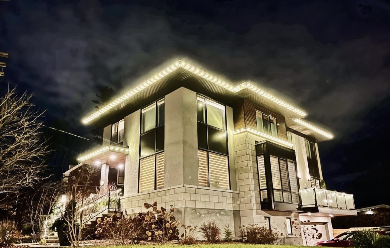 Modern home with white LED lights outlining the roof at night