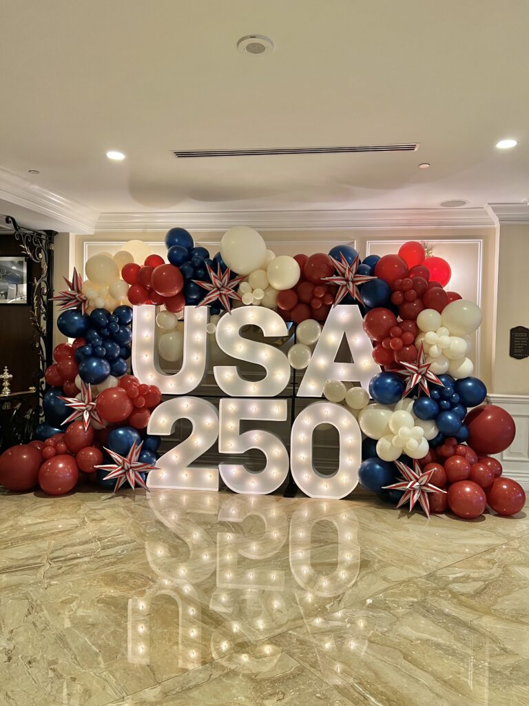 USA 250 light-up marquee letters with patriotic balloon garland